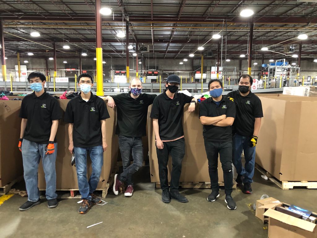 Unio Tech Solutions team helping Give Back Box with sorting in a warehouse